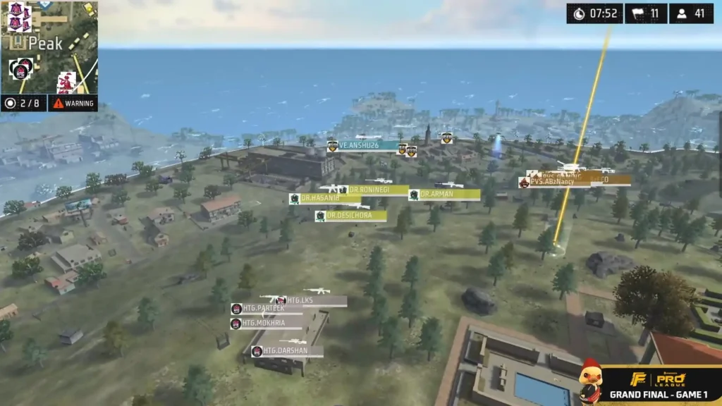Aerial view of a ffmic 2025 battlefield near the ocean, with teams and player stats displayed in a tactical setup during a match.
